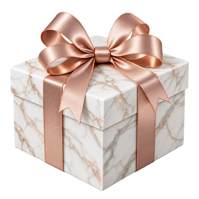 A white marble-patterned box wrapped with a rose gold-colored ribbon and a broad bow