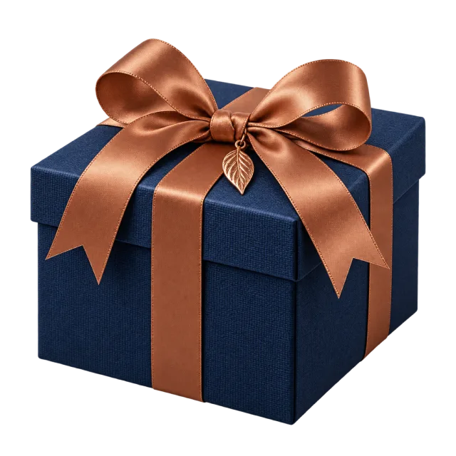 A square navy gift box wrapped in a copper-colored ribbon with a small leaf-shaped charm