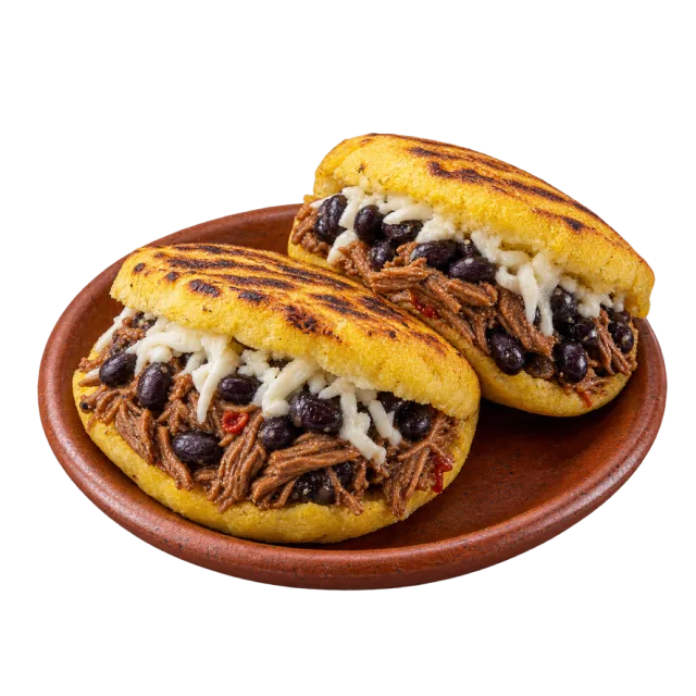 Two golden arepas filled with shredded meat, dark beans and grated cheese on a brown plate
