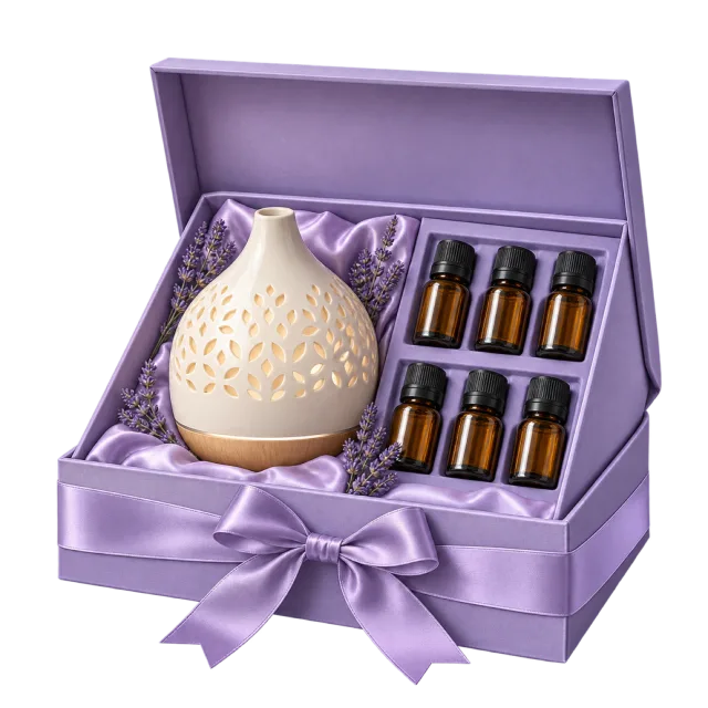 A lavender-colored box holds a white patterned diffuser and small amber bottles