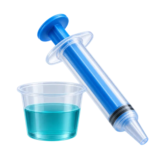 A blue oral syringe sits beside a small cup of turquoise liquid