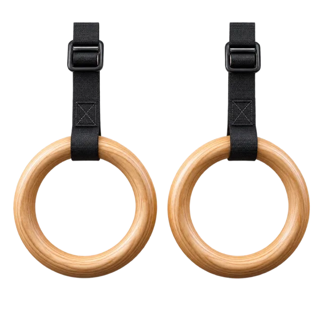 Two wooden gymnastic rings hang from black straps