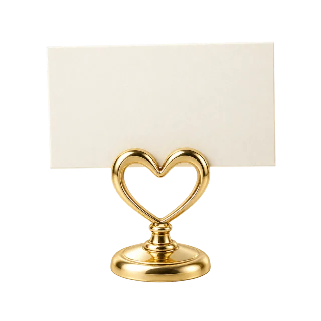 A gold-colored heart-shaped holder displays a blank cream card