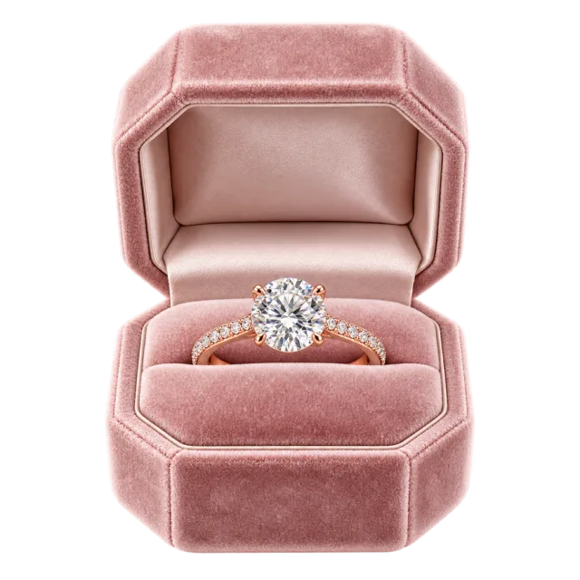 A pink ring box displays a clear-stone ring