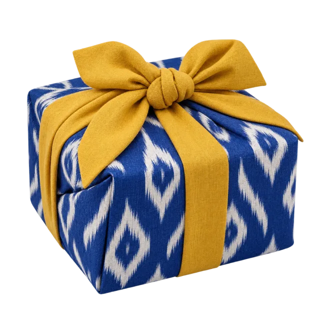 A blue-and-white ikat-patterned parcel with a mustard-yellow ribbon and bow