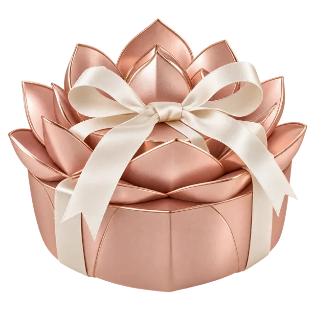 A blush-pink lotus-shaped box with layered petals and a cream bow