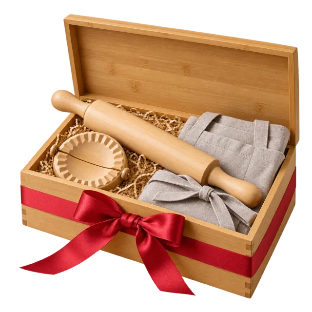 A wooden gift box holding a rolling pin, round dumpling press and folded cloth, with a red bow