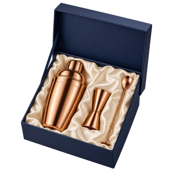A navy presentation box containing a copper-colored cocktail shaker and matching bar tools