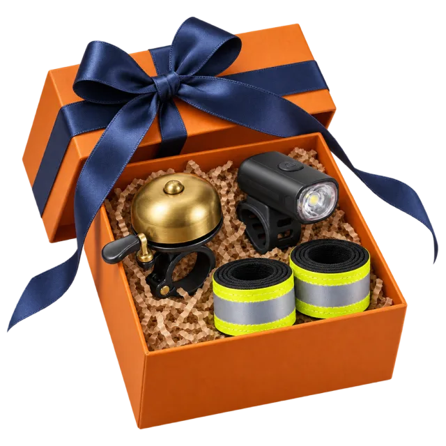 An orange gift box with a gold bicycle bell, a dark light and bright reflective bands beneath a navy bow