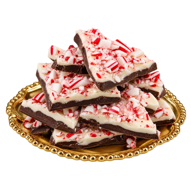 Layered chocolate bark pieces topped with crushed red and white candy on a gold-colored plate