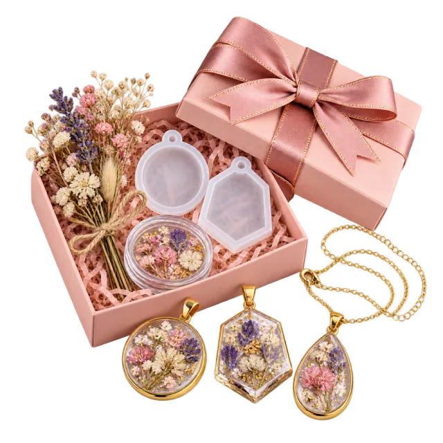 Pink jewelry craft box with dried flowers, small molds and floral pendants