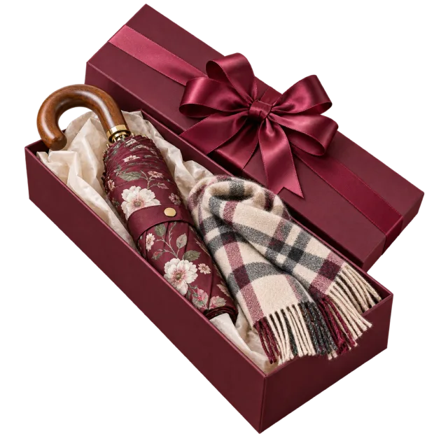 Burgundy gift box containing a folded umbrella and a checked scarf