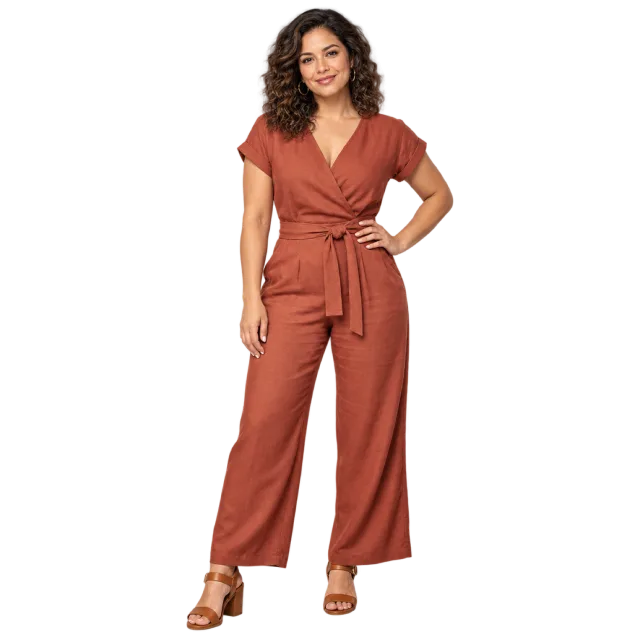 Woman wearing a terracotta wrap-style jumpsuit with one hand on her hip