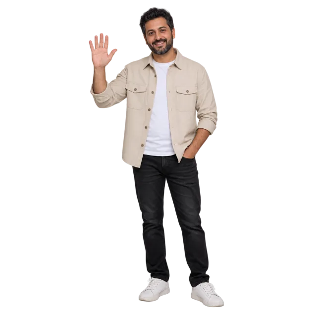 Man waving while wearing a beige overshirt, white T-shirt and black trousers
