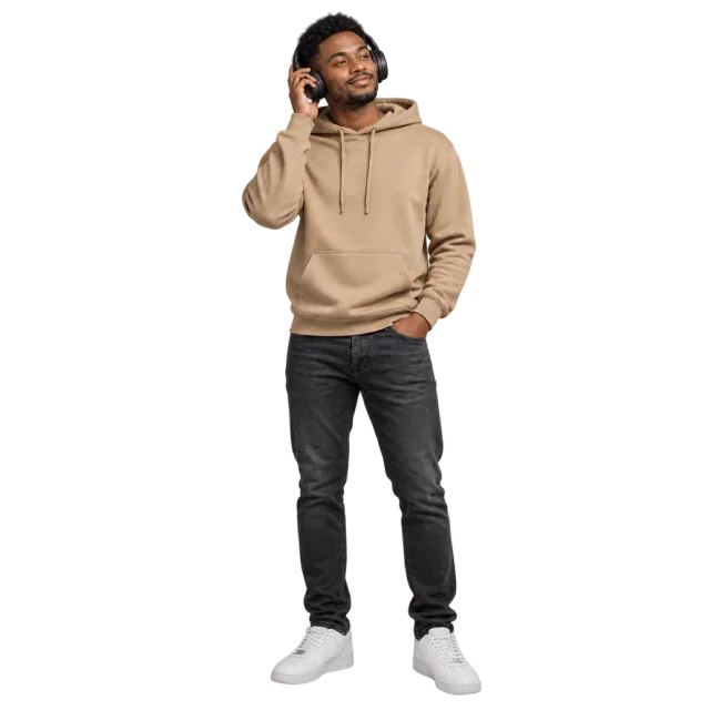Man in a beige hoodie and dark trousers touching one earcup of his headphones
