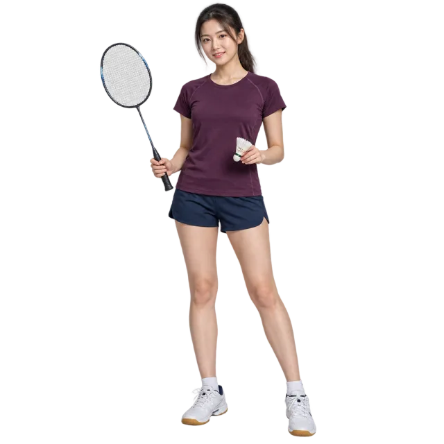 Woman in a plum T-shirt and navy shorts holding a badminton racket and shuttlecock