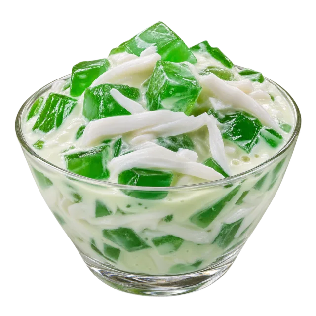 Clear glass bowl of buko pandan dessert with green jelly pieces and white coconut strips