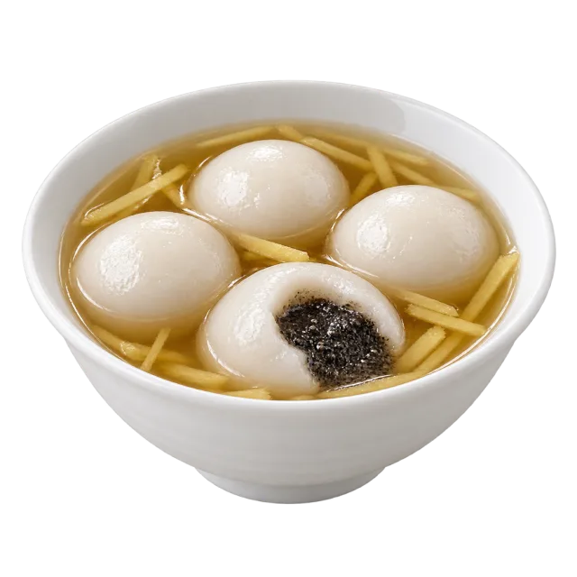 White tangyuan rice balls in golden broth, with one cut open to show a dark filling