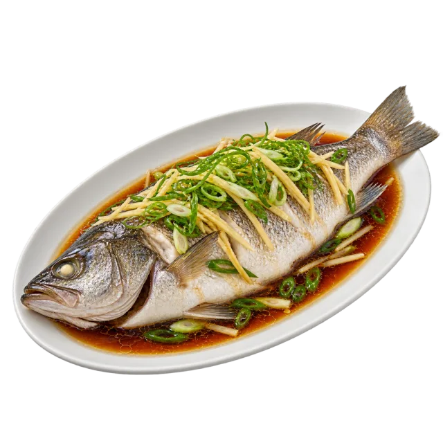 Whole steamed fish in dark sauce topped with thin ginger strips and green onion