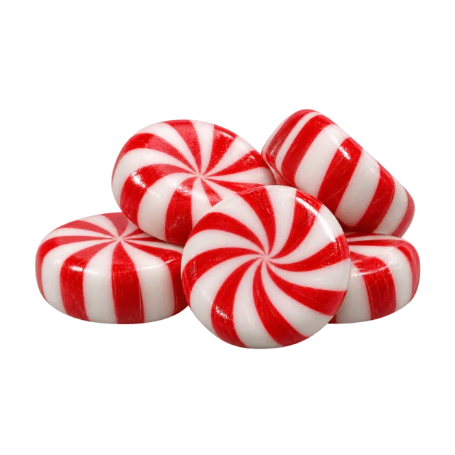 A small pile of round red and white striped peppermint candies
