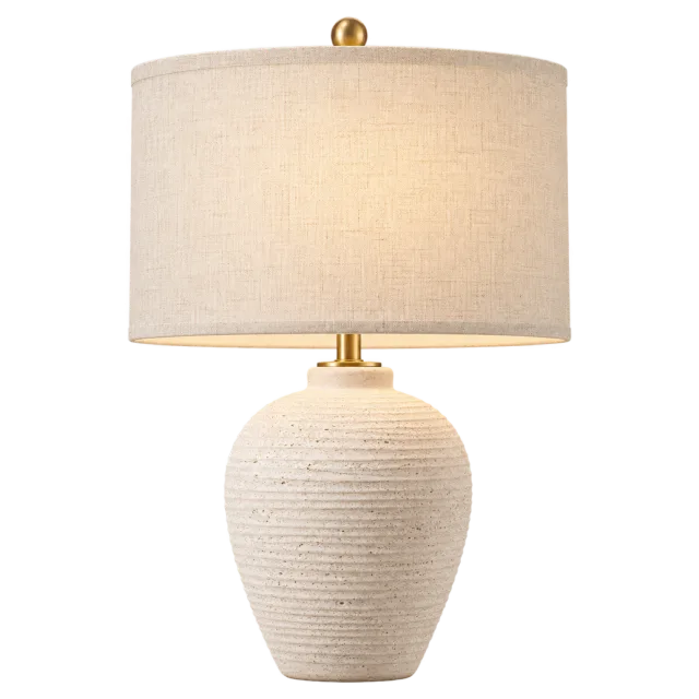 Cream ceramic bedside lamp with a textured base and fabric drum shade