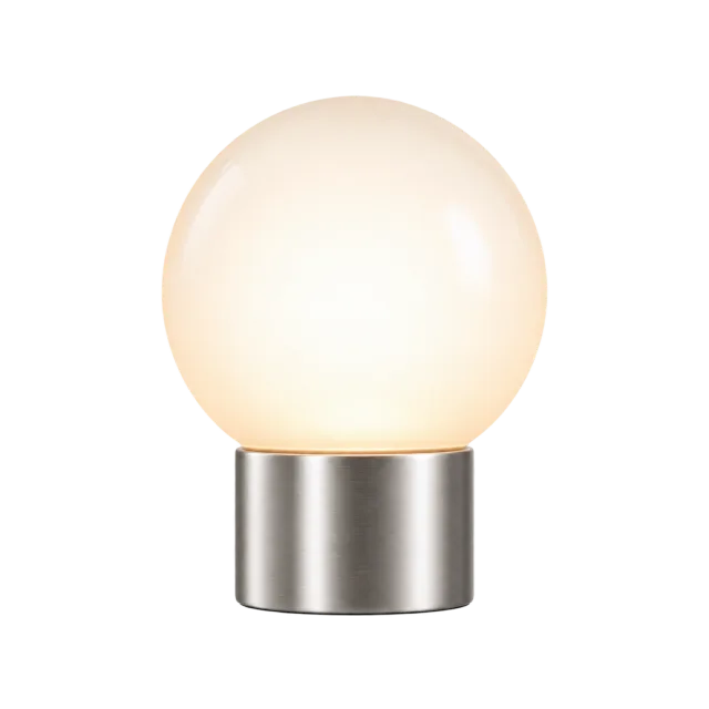 Glowing frosted globe bedside lamp on a short silver-colored base