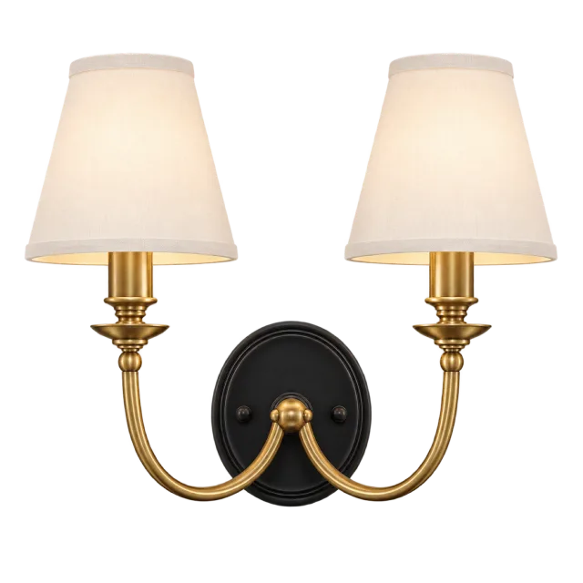 Double-arm brass-colored wall sconce with two cream shades and a black backplate