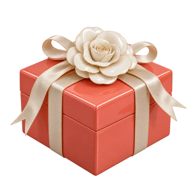 Coral square gift box with ivory ribbons and a cream camellia flower