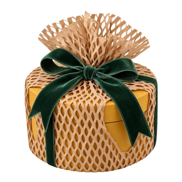 Gift box wrapped in honeycomb paper with a dark green bow