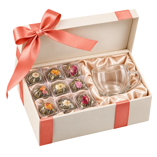 Cream tea gift box with wrapped flower tea portions and a clear glass cup