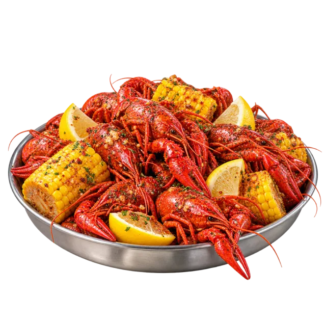 Red crawfish piled on a metal platter with corn pieces and lemon wedges