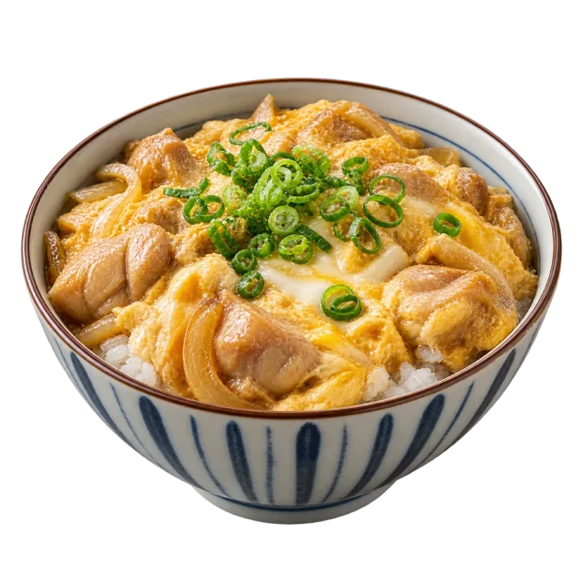 Rice bowl topped with chicken pieces, softly set egg and sliced green onions