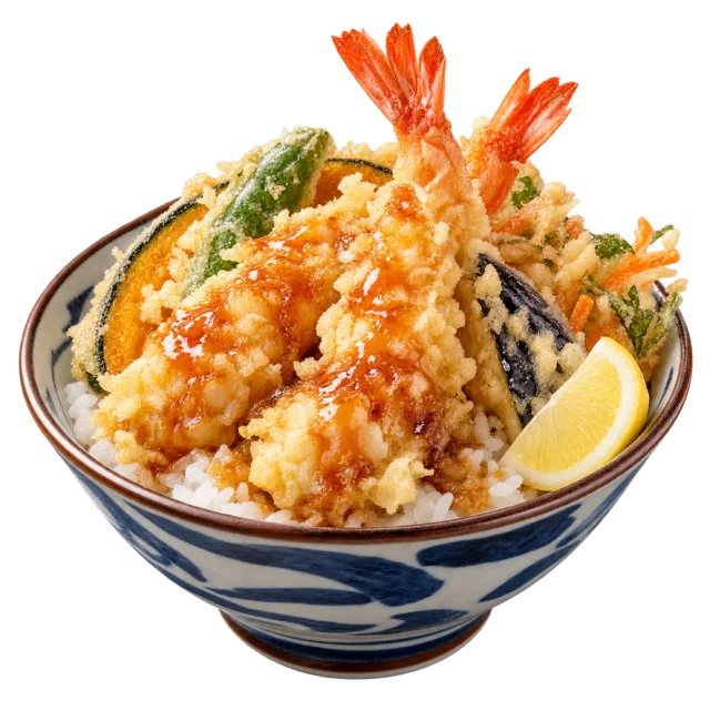 Patterned rice bowl piled with shrimp and vegetable tempura and a lemon wedge