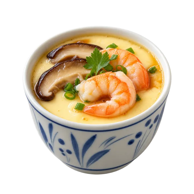 Small patterned cup of pale steamed custard topped with shrimp, mushrooms and herbs