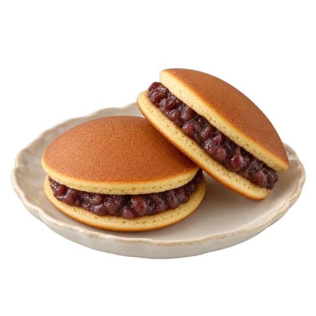 Round pancake sandwiches with dark red bean filling on a cream plate