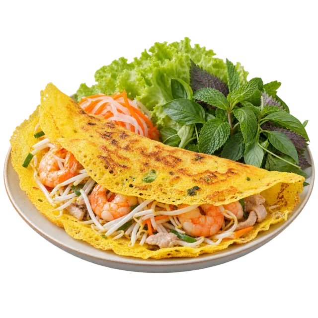 Folded golden crepe filled with shrimp and bean sprouts beside leafy herbs