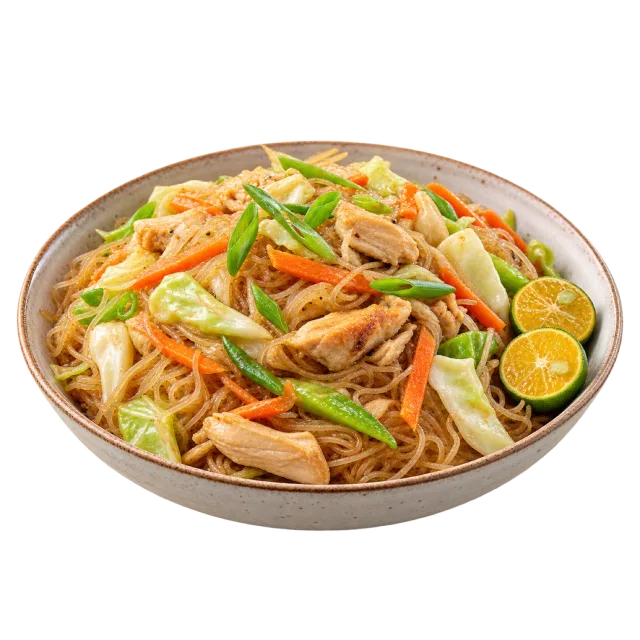 Plate of thin noodles with vegetables, meat strips and small citrus halves