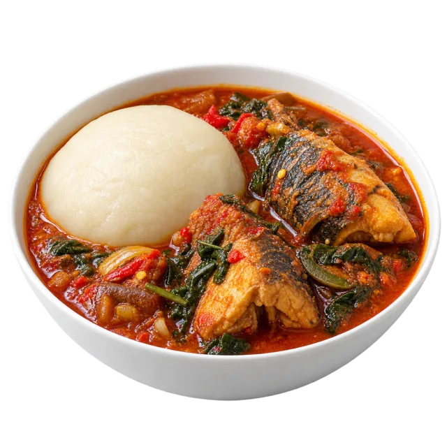 White fufu mound in reddish soup with fish pieces and vegetables