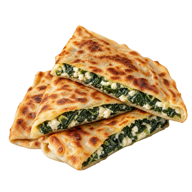 Triangular browned flatbread pieces with visible leafy green and white cheese filling