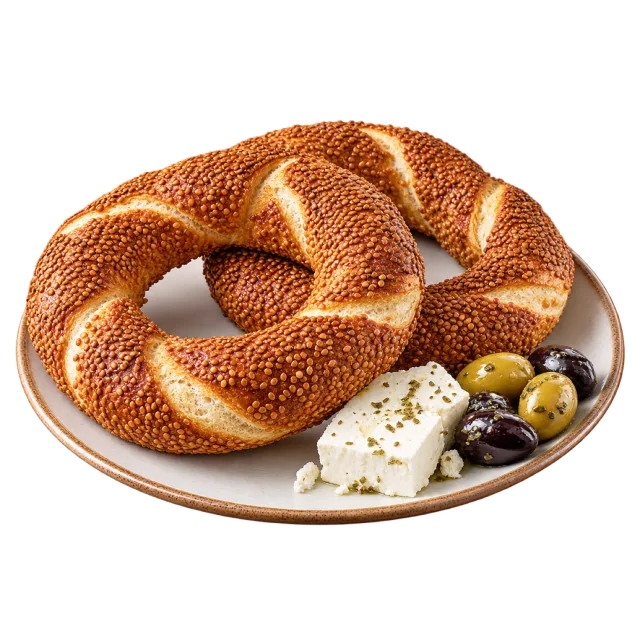 Sesame-covered twisted bread rings on a plate with olives and white cheese