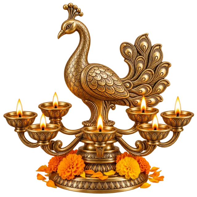 Gold-colored peacock centerpiece with several lit oil lamps and orange flowers at the base