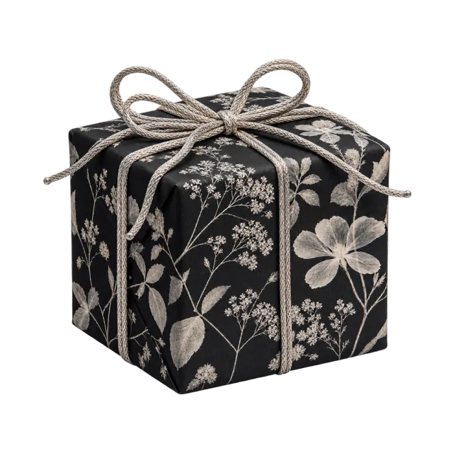 Black floral-patterned parcel tied with silver-colored cord
