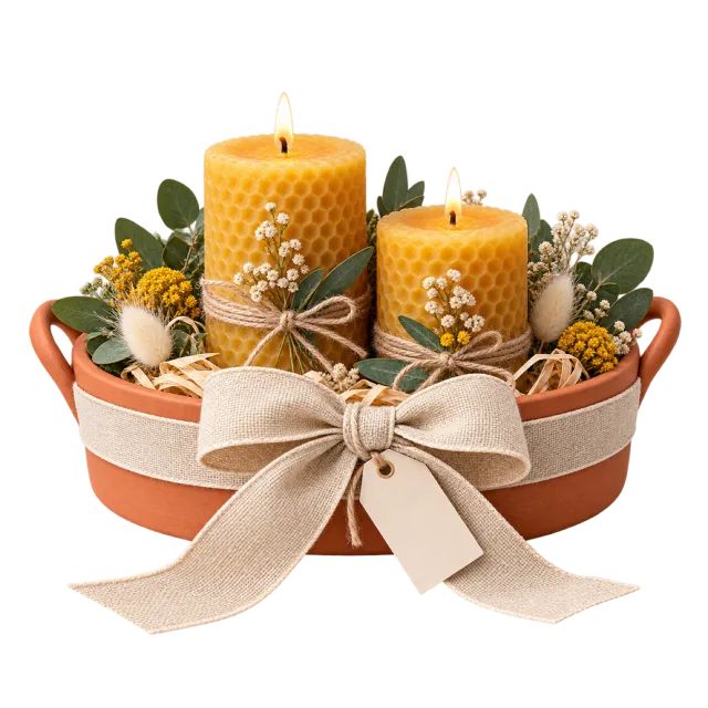 Two lit yellow textured candles on a terracotta-colored tray