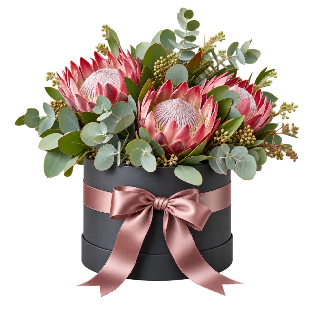 Pink proteas and eucalyptus in a charcoal round gift box