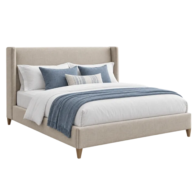 A beige upholstered bed with white pillows, blue accent cushions and a blue throw