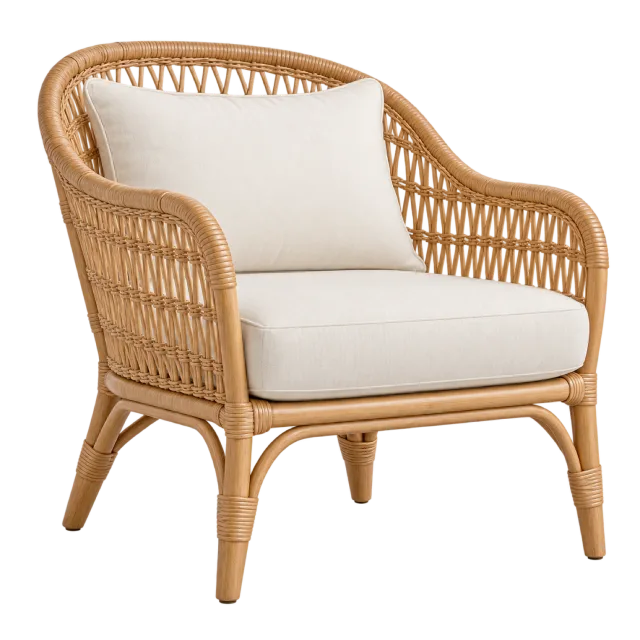 A natural woven rattan armchair with curved sides and white seat and back cushions