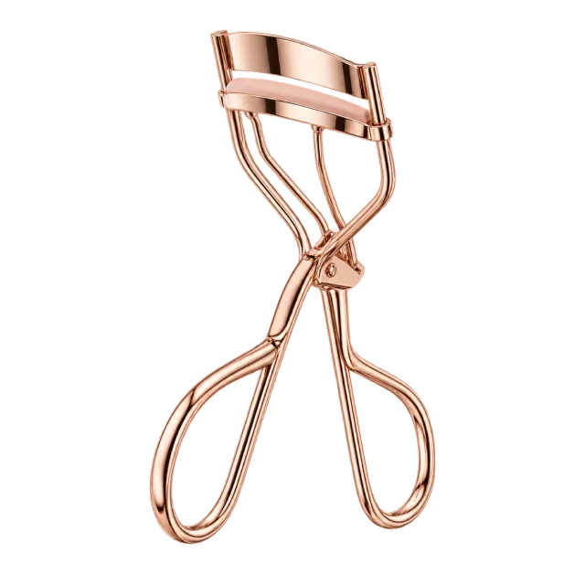 Realistic-style illustration of rose gold eyelash curler