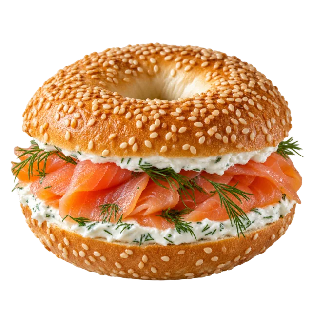 A sesame bagel filled with salmon slices, cream cheese and fresh dill