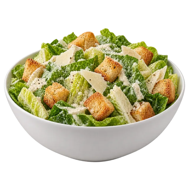 A white bowl of lettuce with croutons, shaved cheese and creamy dressing