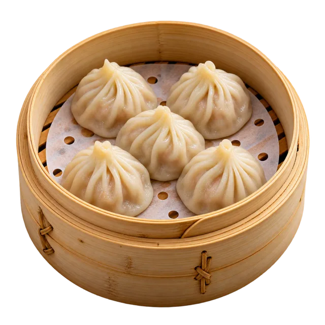 Four pleated steamed dumplings arranged inside a round bamboo steamer
